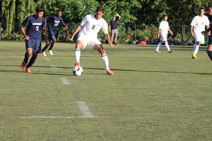 Captain Vinny Silva dribbling the ball away from Lawrence.