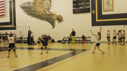 Malden team prepares a serve against the Medford team.