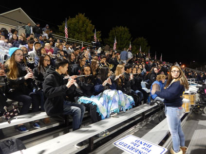 Malden High School band participating in a Friday football game, led by their Senior drum major Paula Armentor.