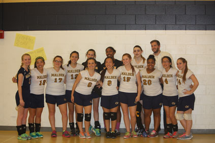 The Girls Varsity Volleyball team posing for a group photo.