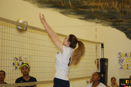 Junior, Victoria Tortora hitting the ball over the net.