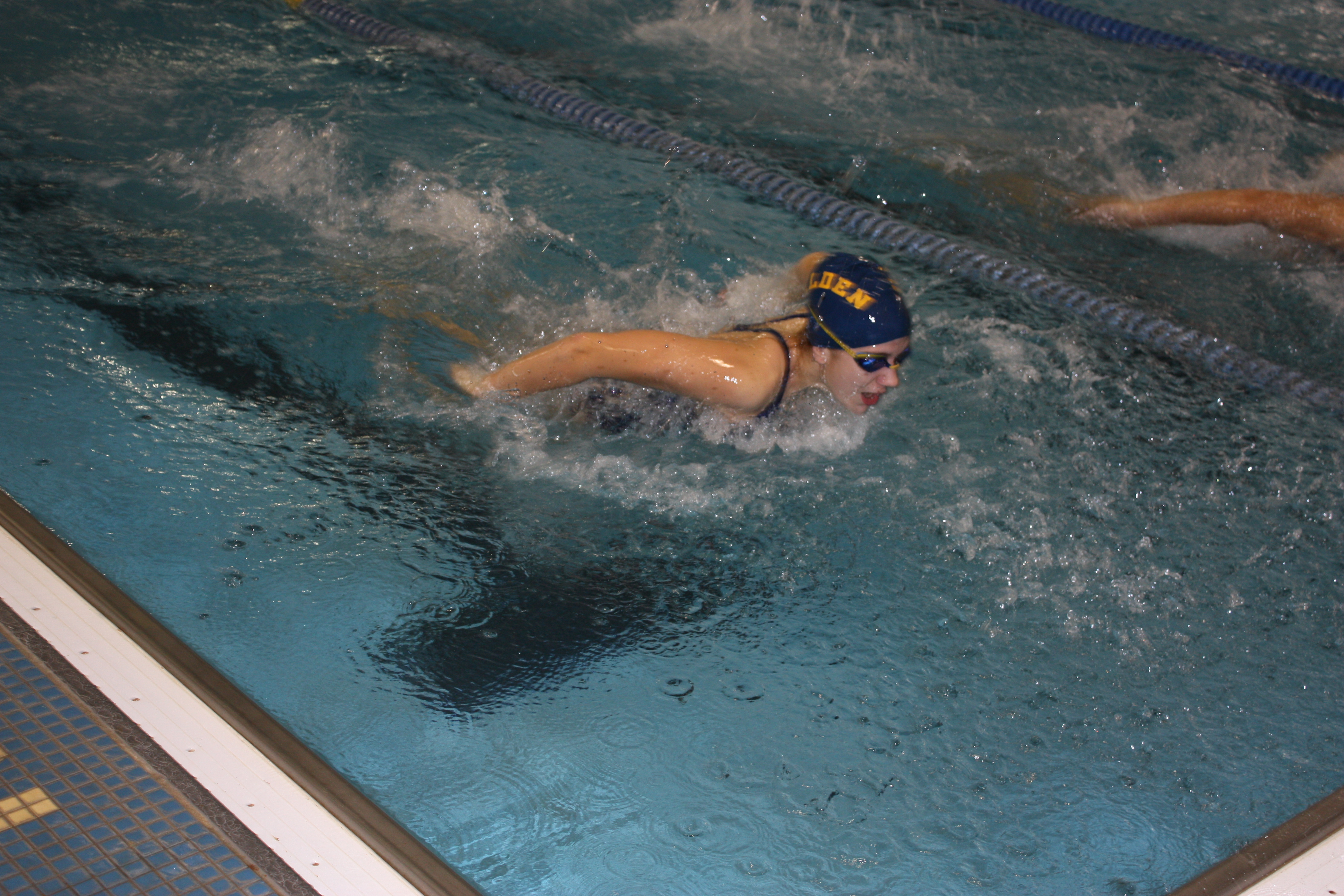 Junior Alex Lombardi swimming the 100 yard butterfly. Photo by Ana Kerr