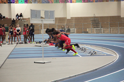  Malden runner sprints off the starting block of the 55m dash against competitors.