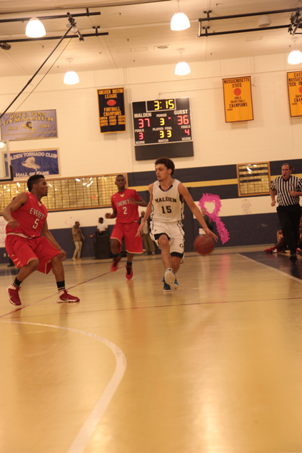  Junior Mark Rogers dribbles the ball up the court. 
