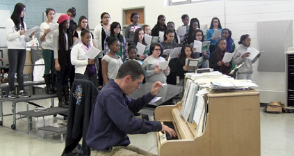 Mixed Chorus teacher, Todd Cole, playing the piano while the class sings along. Photo by Roberto De Oliveira. 