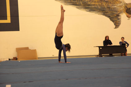 Junior Sabrina Harrath doing a handstand.