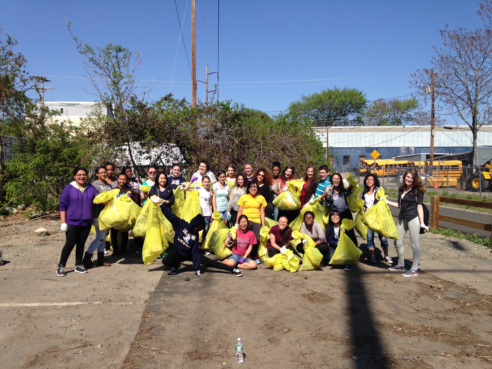 Students line up for a picture with large bags of garbage they had collected on their Beautification Day. Photo by Abbey Dick.