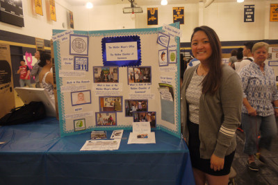 Senior Christine Fang with her internship poster. Photo by Tatyanna Cabral. 