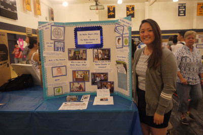 Senior Christine Fang with her internship poster. Photo by Tatyanna Cabral.