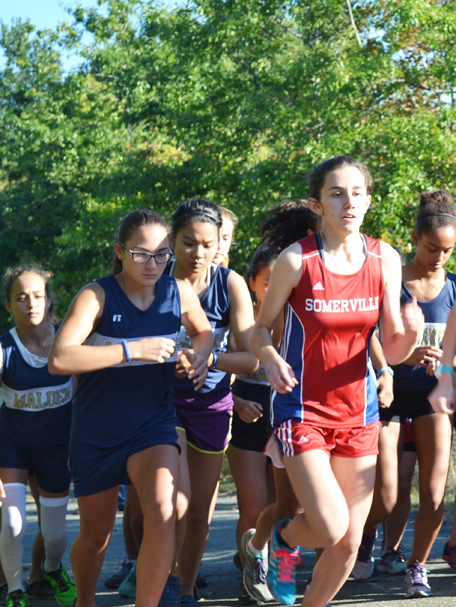Left: Allie Russo starting out at the meet against Somerville. Photo by Jesaias Benitez. 