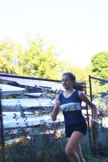 Sophomore and Blue and Gold member Anna Powers running during the meet against Somerville. Photo by Jesaias Benitez.