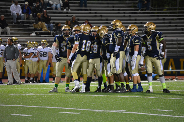 Malden High School's football team in a huddle.
