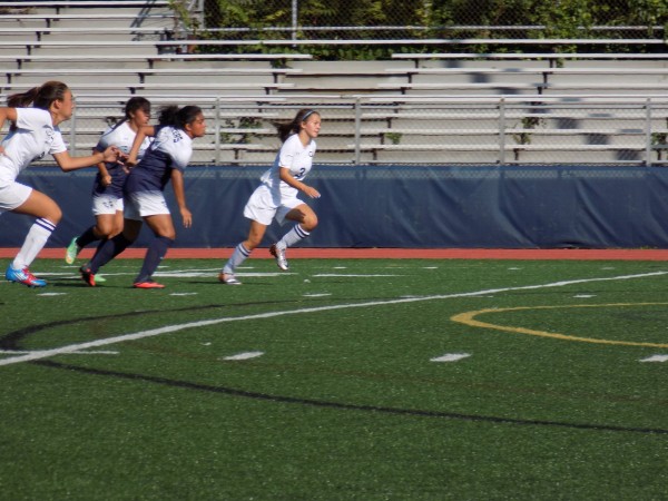 Junior Cleverina Cong rushes up the field alongside her teammate freshman Jill Tramandozzi. Photo by Liam Elliott. 