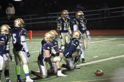 The Malden football team resting before the start of play. Photo by Leila Greige. 