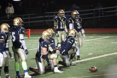 The Malden football team resting before the start of play. Photo by Leila Greige.