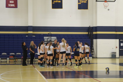 The volleyball team in a group huddle. Photo by