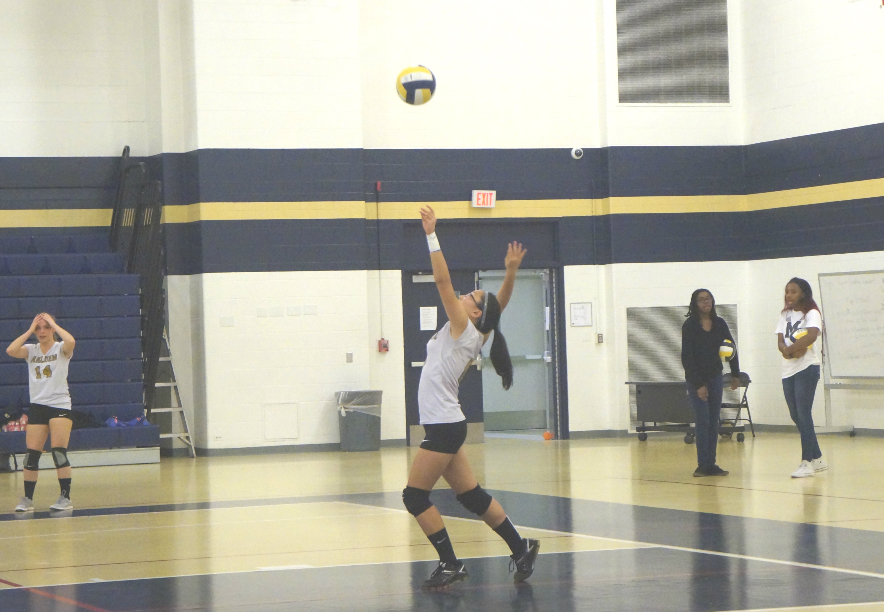 Senior Michelle Huang about to hit the ball. Photo by Meghan Yip.