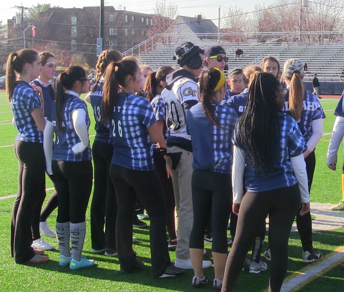 The junior powderpuff team in a huddle during the game. Photo by Tenzin Dorjee.