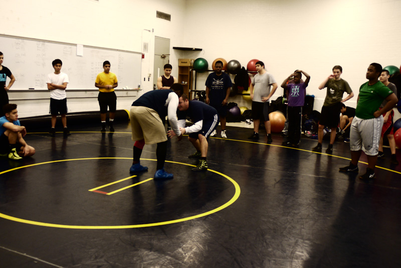 Coach Jeremiah Smith teacher students how to wrestle. Photo by Joanna Li.