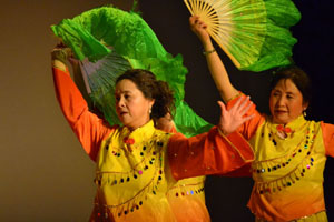 Dancers performing a traditional dance with fans. Photo by Kristy Yang. 