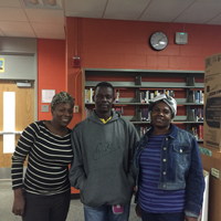 Teachers Roseline Borgella, Ezner Angervil, and Vana Edmond at the MHS library. Photo by Sydney Stumpf. 