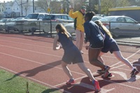 Sophomore Allie Russo, senior Deborah Kibazo, and senior Gillian Willcox preparing for the 800m race. Photo by Alysha McDevitt. 