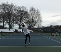 Senior Edward Gu serving the ball. Photo by Ailin Toro. 