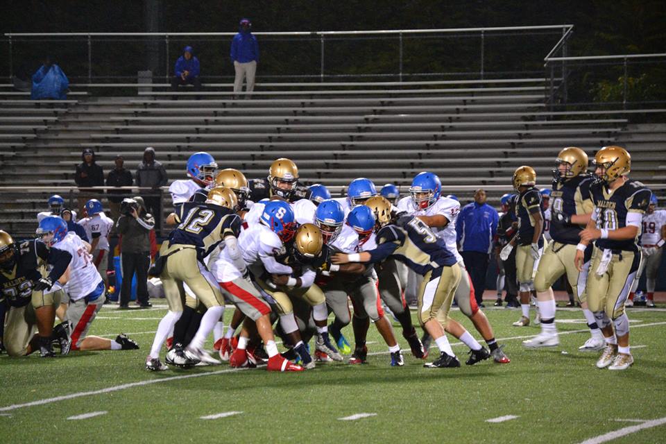 Malden High players pushing the pile to gain extra yards. Photo taken by Abhishek Rana  