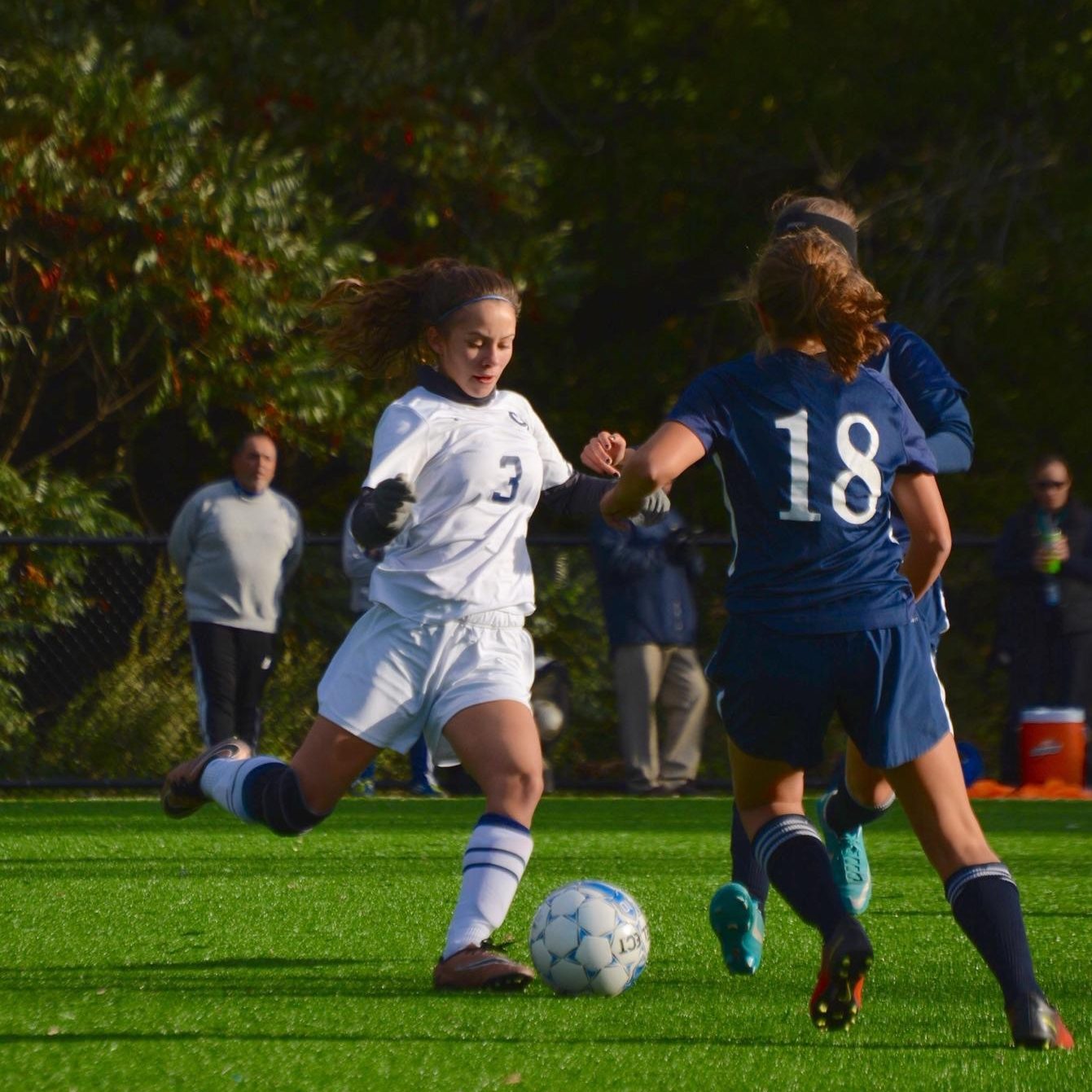 Junior Isabelly Barros runs down the field against two Medford players to look for a goal. Photo taken by Abhishek Rana. 