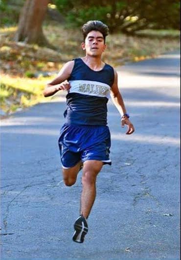 Junior Juan Buenrostro running during a meet. Photo by Toby Pitan.