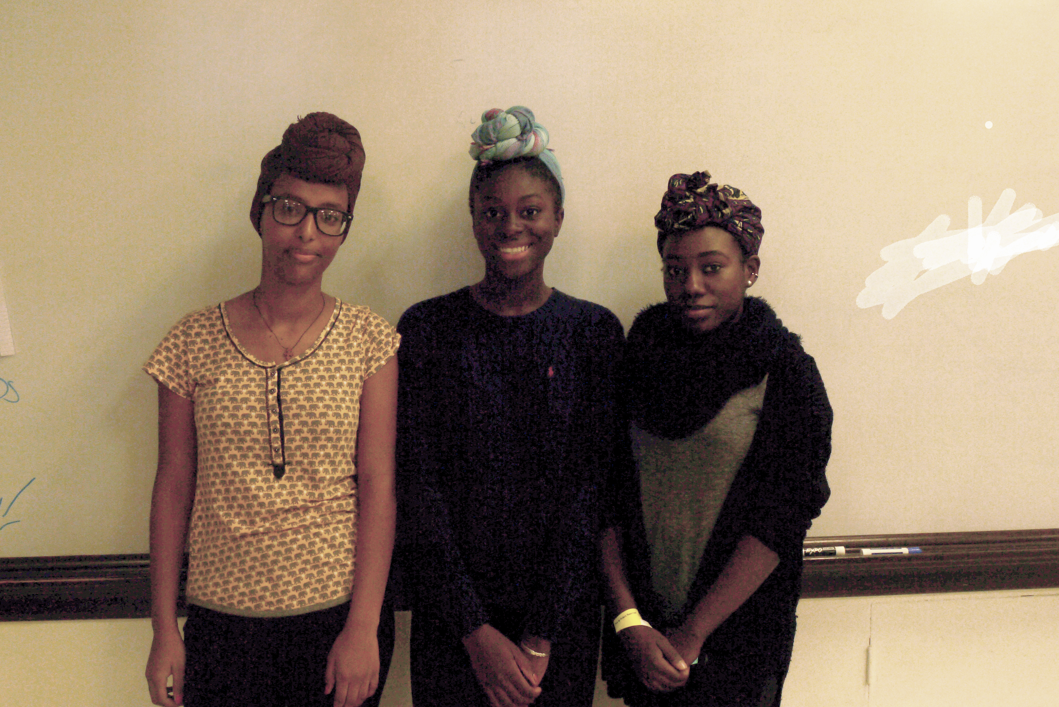 From left to right: sophomore Birukti Tsige, sophomore Cedrina Missamou and junior Ruthie Bilimo wearing headwraps. Photo taken by Tenzin Dorjee.