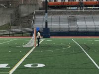 A Malden goalie watches the action from the other side of the field.