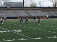 A group from Malden's opponent, Winthrop, start walking towards the middle of the field.