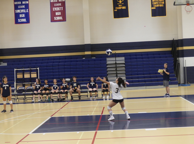 Senior Myo Theingi serving the ball. photo by Roxane Leon