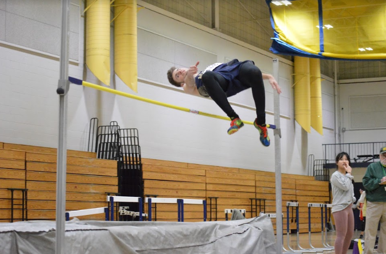 Senior Ezra Kruckenberg competing in the high jump. Photo by David Cartledge