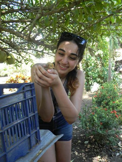 Senior Racha Oumark holding a baby chick. THOMAS TIERNEY